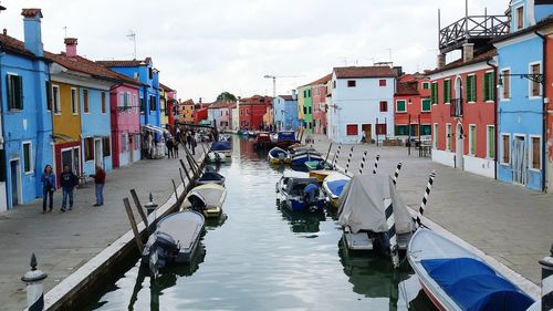 Boats in canal along buildings