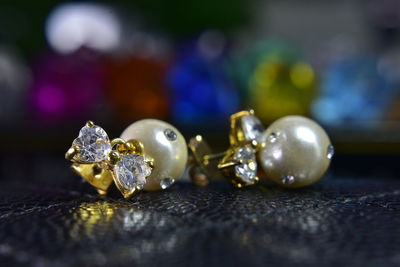 Close-up of earrings on table