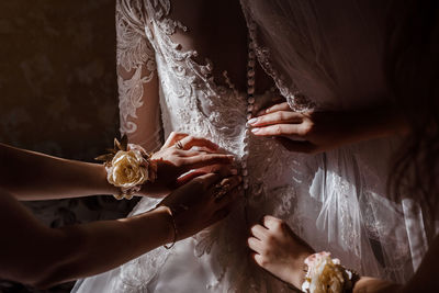 Midsection of couple holding hands