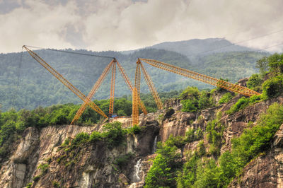 Low angle view of cranes on mountains