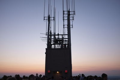 Crowd at observation point against sky during sunset