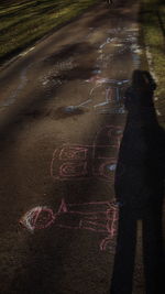 High angle view of woman with text on street in city