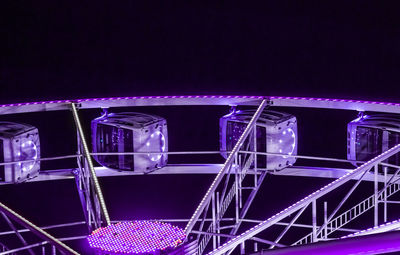 Low angle view of illuminated ferris wheel at night