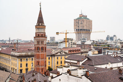 View of buildings in city against clear sky