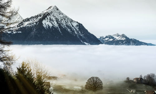 Scenic view of snowcapped mountains against sky