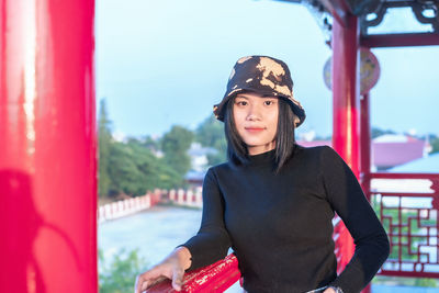 Portrait of young woman standing outdoors