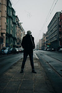 Full length of man standing on street in city