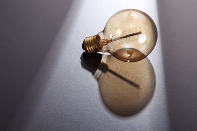Close-up of light bulb on table