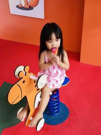 Portrait of a girl sitting with toy