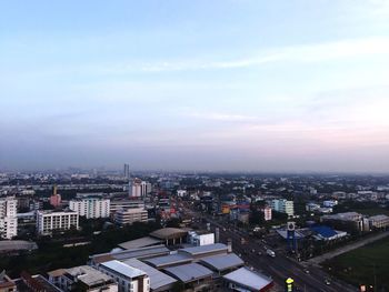 Cityscape against cloudy sky