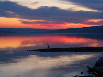 Scenic view of sea against orange sky