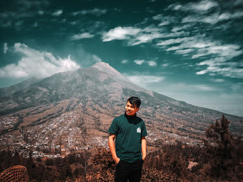 Man standing on mountain against sky