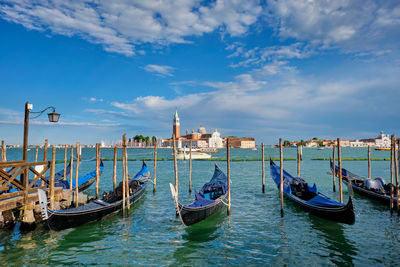 Gondolas and in lagoon of venice by san marco square. venice, italy