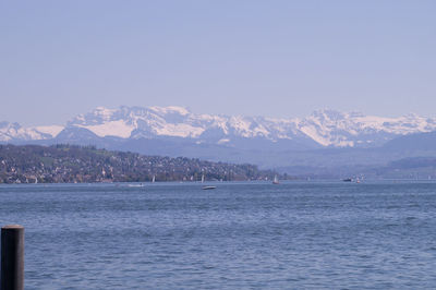 Scenic view of sea and mountains against sky