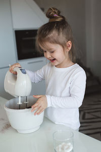 Cute girl making cake batter