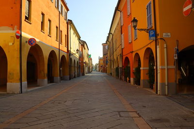 Empty alley amidst buildings in city