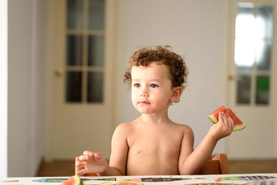 Portrait of shirtless boy at home