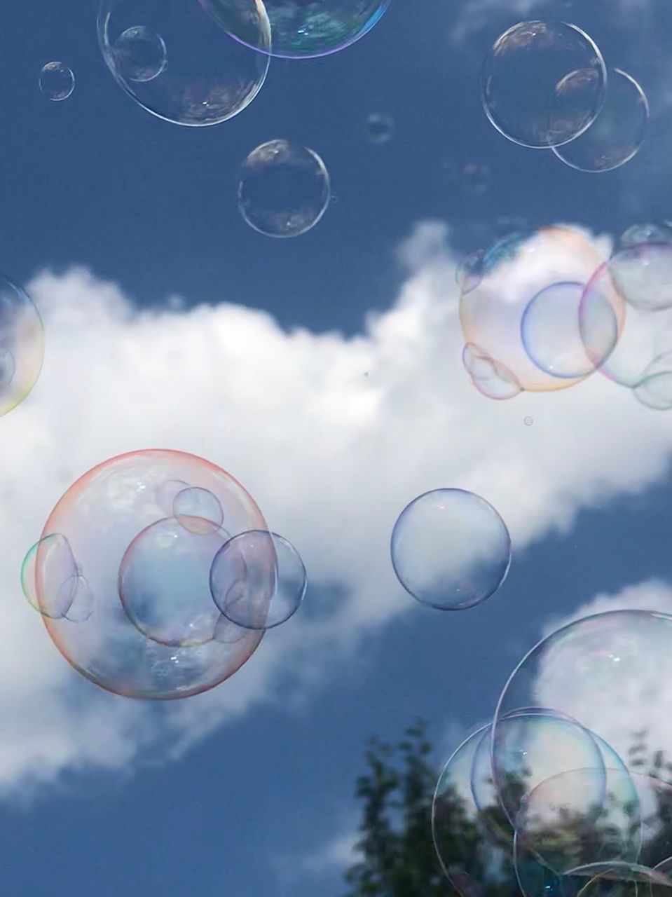 LOW ANGLE VIEW OF BUBBLES AGAINST SKY AT NIGHT