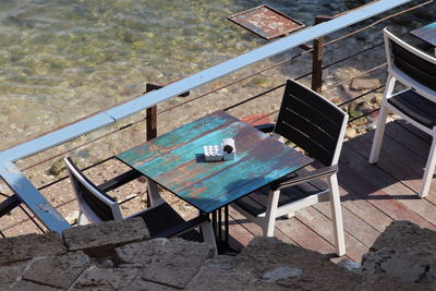 High angle view of chairs on table at swimming pool