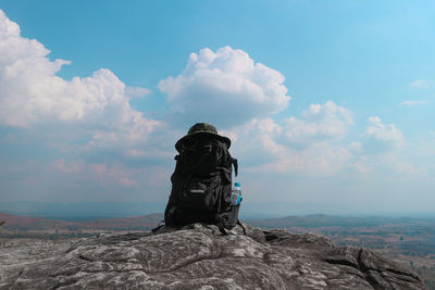 Rear view of rock on mountain against sky