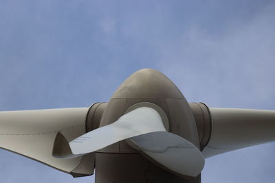 Low angle view of airplane flying against sky