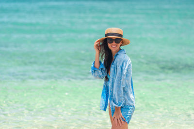 Side view of young woman standing on beach