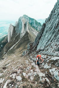 Man surfing on rock against sky