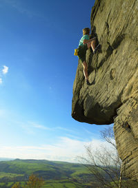 Man bouldering on grid stone in the peak district / uk