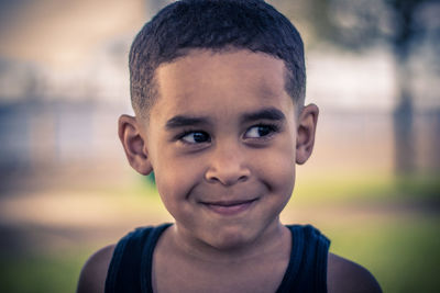 Close-up of boy smiling while looking away