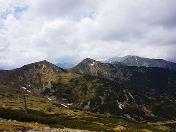 Scenic view of mountains against cloudy sky