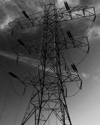 Low angle view of electricity pylon against sky