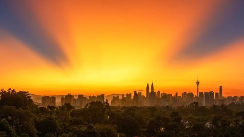 Cityscape against sky during sunset