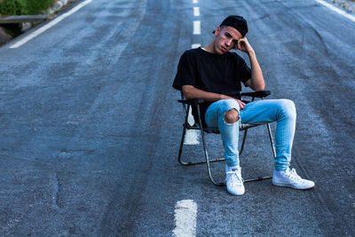 Young man using mobile phone while sitting in car