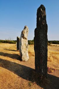 Stone wall on landscape against clear sky