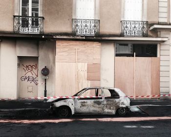 Burnt car on street after riot