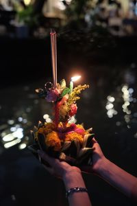 Person holding bouquet of flower on loi kra thong festival in thailand