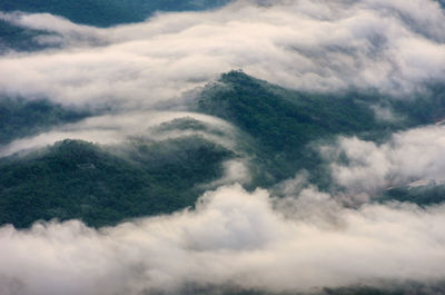 Scenic view of mountain amidst clouds