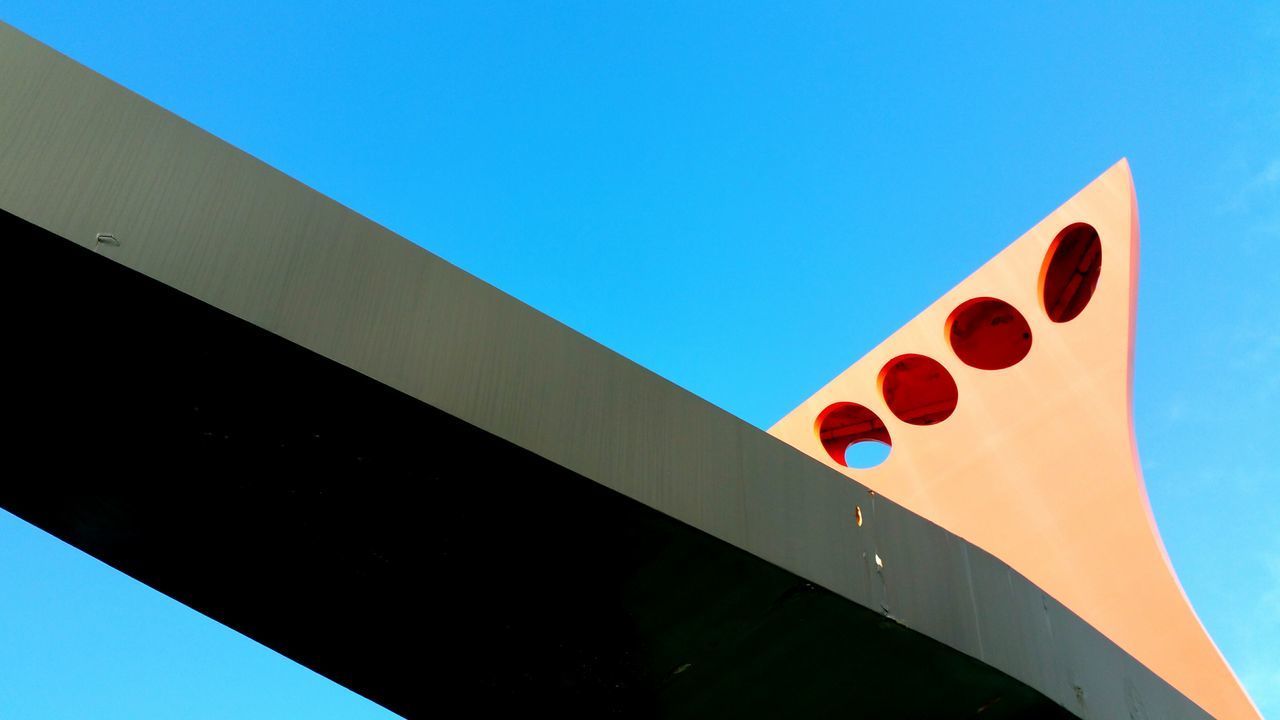 low angle view, clear sky, blue, multi colored, outdoors, day, no people, curve, high section