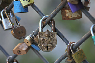 Close-up of padlocks hanging on railing