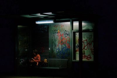 People sitting by window at night