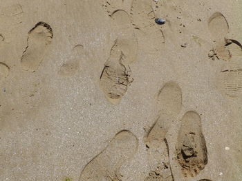 High angle view of footprints on sand