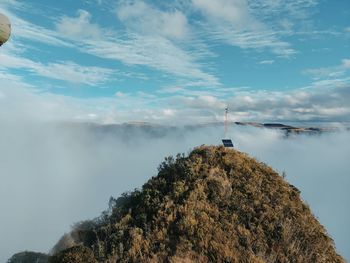 Panoramic view of hill with fog and antenna