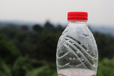 Close-up of water drop on bottle