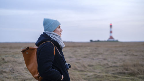 Side view of woman against light house