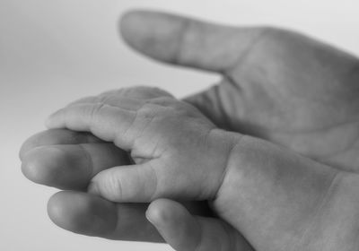 Close-up of baby and mother hands