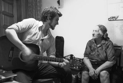 Two men playing guitar