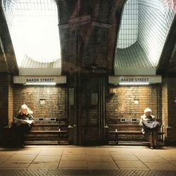 Full length of woman standing by railing