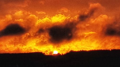 Low angle view of dramatic sky during sunset