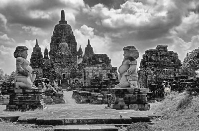 Panoramic view of statue and buildings against sky