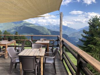 Chairs and table against mountains